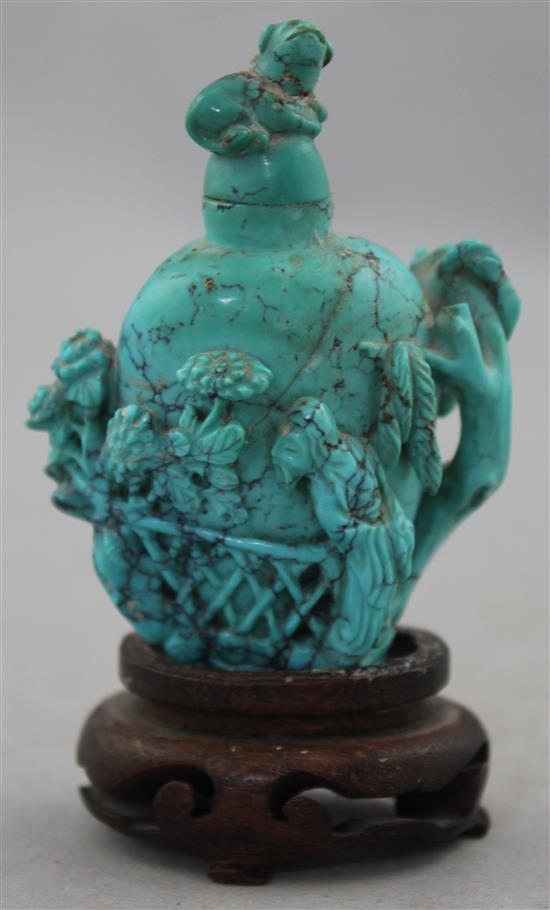 A Chinese turquoise matrix snuff bottle, late 19th / early 20th century, 6.5cm., wood stand, repair to cover